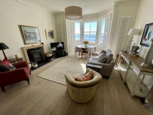 a living room with a couch and a chair at Craigiebank - Lower Largo in Lower Largo