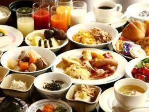 a table full of plates of food and drinks at Hotel Crown Hills Matsuyama in Matsuyama
