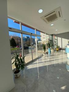 an empty lobby with potted plants in a building at No25 Hotels in Çorlu