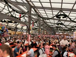 a large crowd of people sitting at tables in a building at Idyllische Wohnung mit Bergblick nah am Simssee in Stephanskirchen