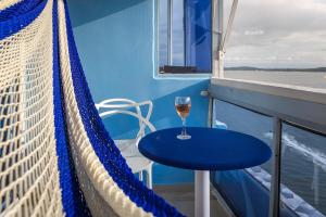 a glass of wine sitting on the balcony of a boat at Balcony to the Horizon in Cartagena de Indias