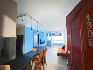 a kitchen with a long counter with chairs in it at Balcony to the Horizon in Cartagena de Indias