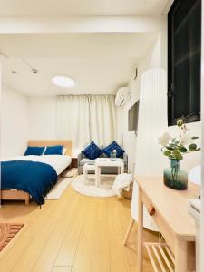 a bedroom with a bed and a living room at Kyo-wa Hotel Kinshicho in Tokyo