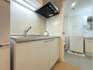 a kitchen with a sink and a refrigerator at Kyo-wa Hotel Kinshicho in Tokyo +68 photos