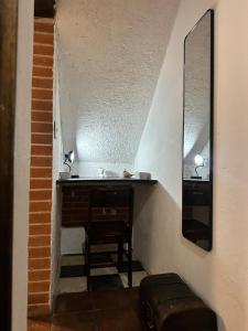 a bathroom with a vanity with a mirror and a stool at Refugio de las Estrellas in Antigua Guatemala