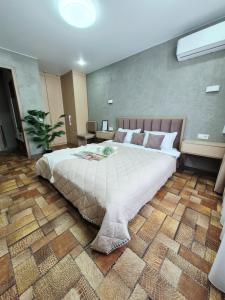 a bedroom with a large bed in a room at Отдых перед и до вылета самолёта in Astana