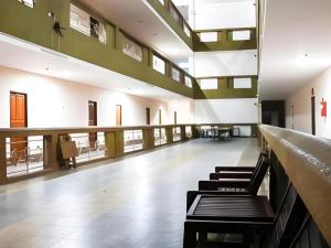 een hal van een gebouw met banken en tafels bij Phuthong Place in Phayao