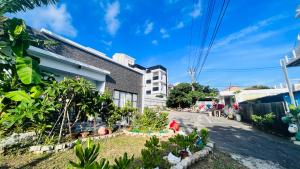 a street in front of a house with plants at 花一村の宿 Huayicun Homestay in Hengchun South Gate