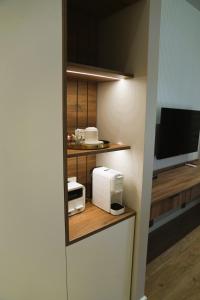 a small kitchen with a microwave and a tv at RA Boutique Hotel in Baku