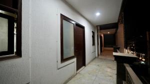 a hallway of a building with a door and a window at Hotel Rustam Residency sec-39 in Gurgaon