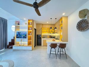 a kitchen with yellow cabinets and a ceiling fan at Manik Tropicana Loft in Canggu