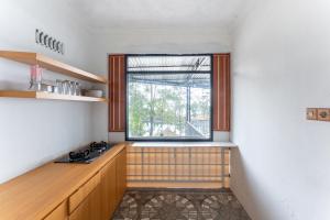 a kitchen with a window in the corner of a room at Sutedjo Telaga bedakah in Bedakah