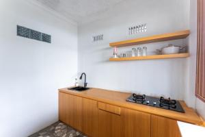 a kitchen with a sink and a stove at Sutedjo Telaga bedakah in Bedakah +5 photos