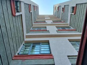 a view up the side of a building with windows at Kinara suites in Kiambu