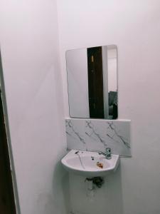a bathroom with a sink and a mirror at Kinara suites in Kiambu +8 photos