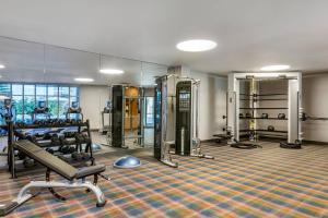 a gym with treadmills and machines in a room at Cambria Hotel LAX in El Segundo