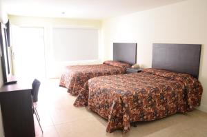 Postel nebo postele na pokoji v ubytování Carl's El Padre Motel