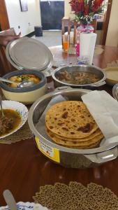 a table with several plates of food on a table at Luxury Villas in Gakuo