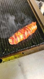 a piece of food cooking on a grill at Luxury Villas in Gakuo