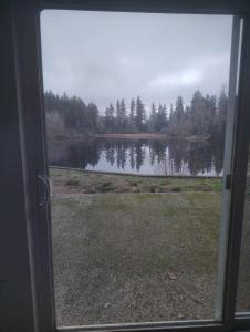 a view of a lake from a sliding glass door at Luxury Villas in Gakuo +2 photos