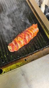 a piece of food cooking on a grill at Luxury Villas in Gakuo