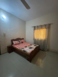 een slaapkamer met een bed en een raam bij La maison de Kalabancoura in Bamako