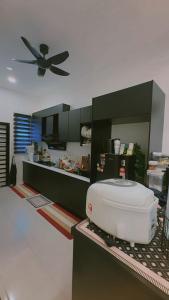 a kitchen with a ceiling fan in a kitchen at NFF Homestay Sendayan Seremban in Labu