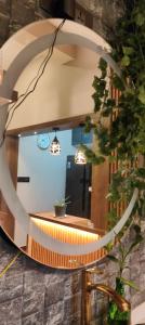 a circular mirror reflecting a counter in a room at Wantara Villa in Vagamon