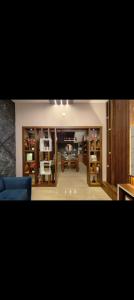 a living room with a blue couch and a dining room at Wantara Villa in Vagamon