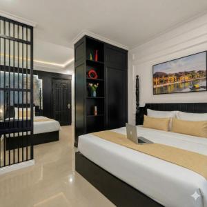 een slaapkamer met 2 bedden en een laptop op een bureau bij The Elegant Boutique - Hue in Hue