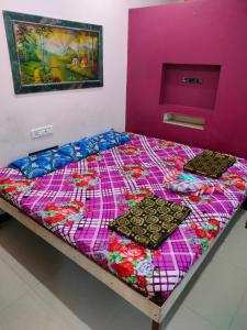 a bed with two trays on top of it at Adarsh Niwas in Malvan