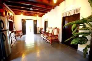 a living room with a bunch of chairs in it at Kandy House Hiriketiya in Dickwella