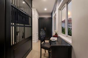 a hallway with a black door and a chair and a desk at The Elegant Boutique - Hue in Hue