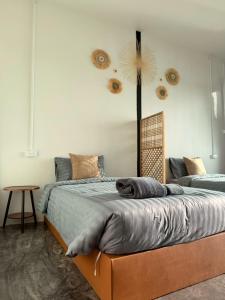 a dog laying on a bed in a bedroom at Malila Sea Breeze Hostel in Ko Tao