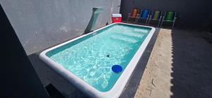 a swimming pool with a blue frisbee in it at Casa Temporada Conchinha do Mar in São Mateus
