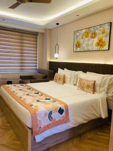 a bedroom with a large bed and a couch at StayWorks studios in Greater Noida