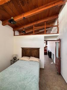 a bedroom with a bed and a wooden ceiling at Casa Palomar in Guanajuato