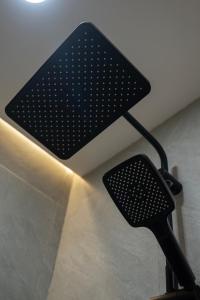 a black chair with a light on the wall at Kaiarasa Villas and Suite in Canggu