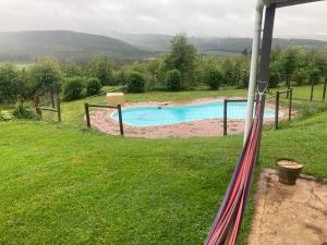 a view of a swimming pool in a yard at Armadale Cottage in Lidgetton