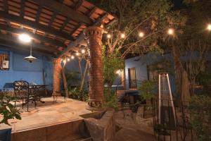 an outdoor patio with a table and chairs and lights at Casa Palomar in Guanajuato