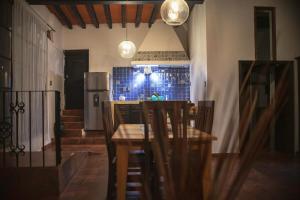 a kitchen with a table and chairs and a refrigerator at Casa Palomar in Guanajuato