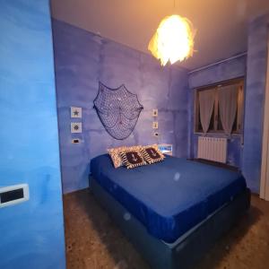 a blue bedroom with a bed in a room at Ocean View House in Nettuno