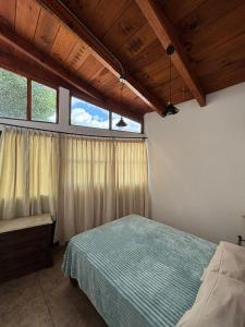 a bedroom with a bed and a window at Casa Palomar in Guanajuato