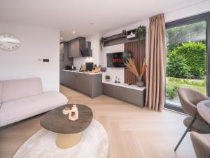 een woonkamer met een bank en een tafel bij Veluwepark de Bosgraaf in Apeldoorn