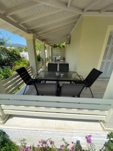 a patio with two chairs and a table on a porch at Dada's Cottage in Argyrádes