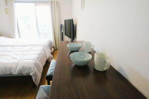 Giường trong phòng chung tại オンブラージュ九203