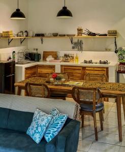 a living room with a table and a kitchen at Little Munduk Villa A Private Mountain Escape in Munduk +19 photos