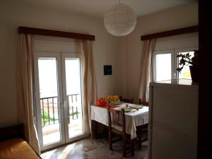a dining room with a table and sliding glass doors at Popy Apartments in Ierapetra