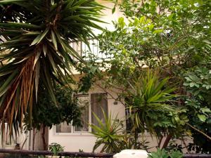 a building with trees and plants in front of it at Popy Apartments in Ierapetra