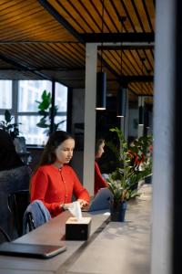 a woman sitting at a table in an office at Capsule Hotel Constellation 91 in Lviv +42 photos